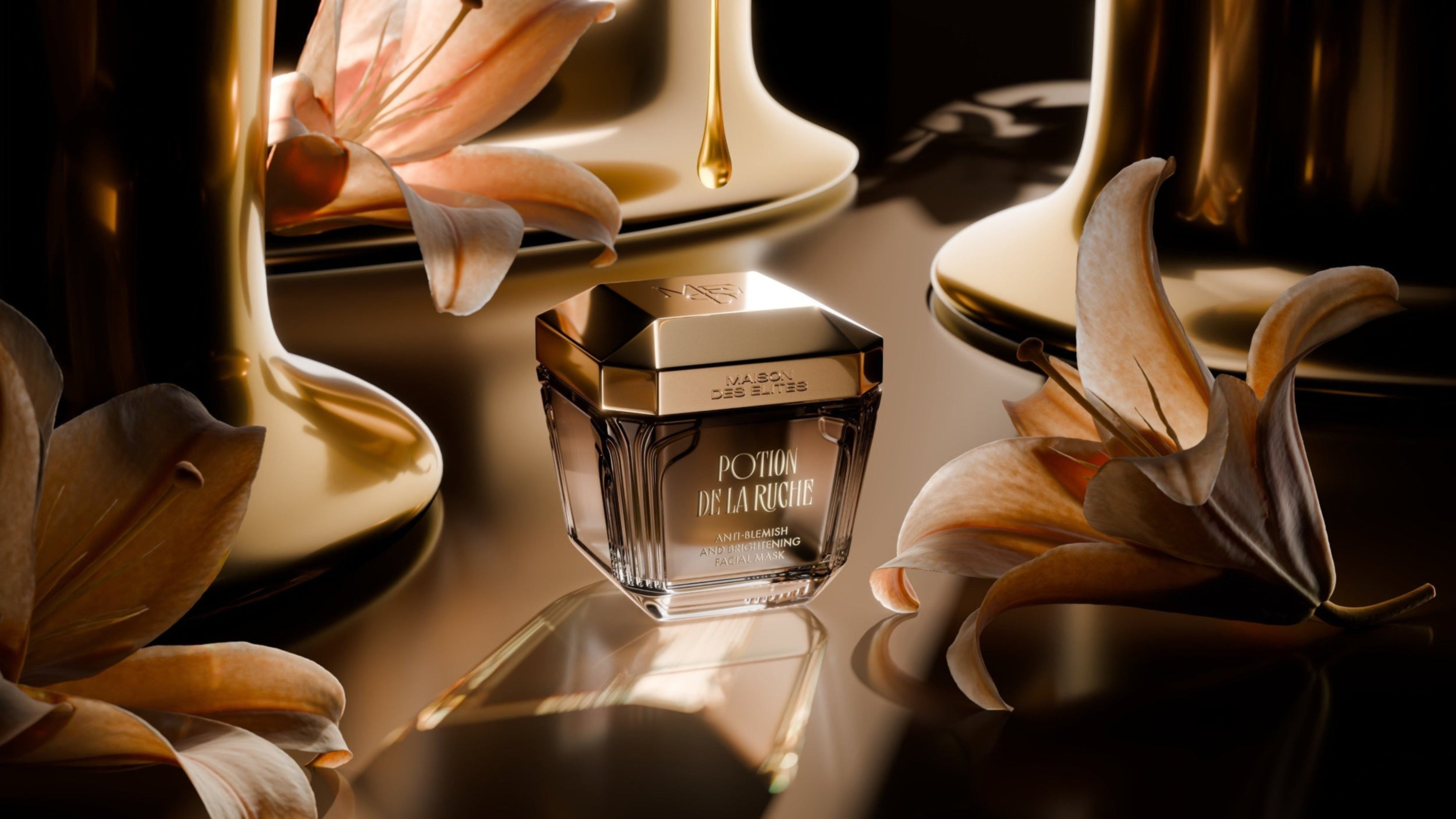 Perfume bottle with flowers on a reflective surface