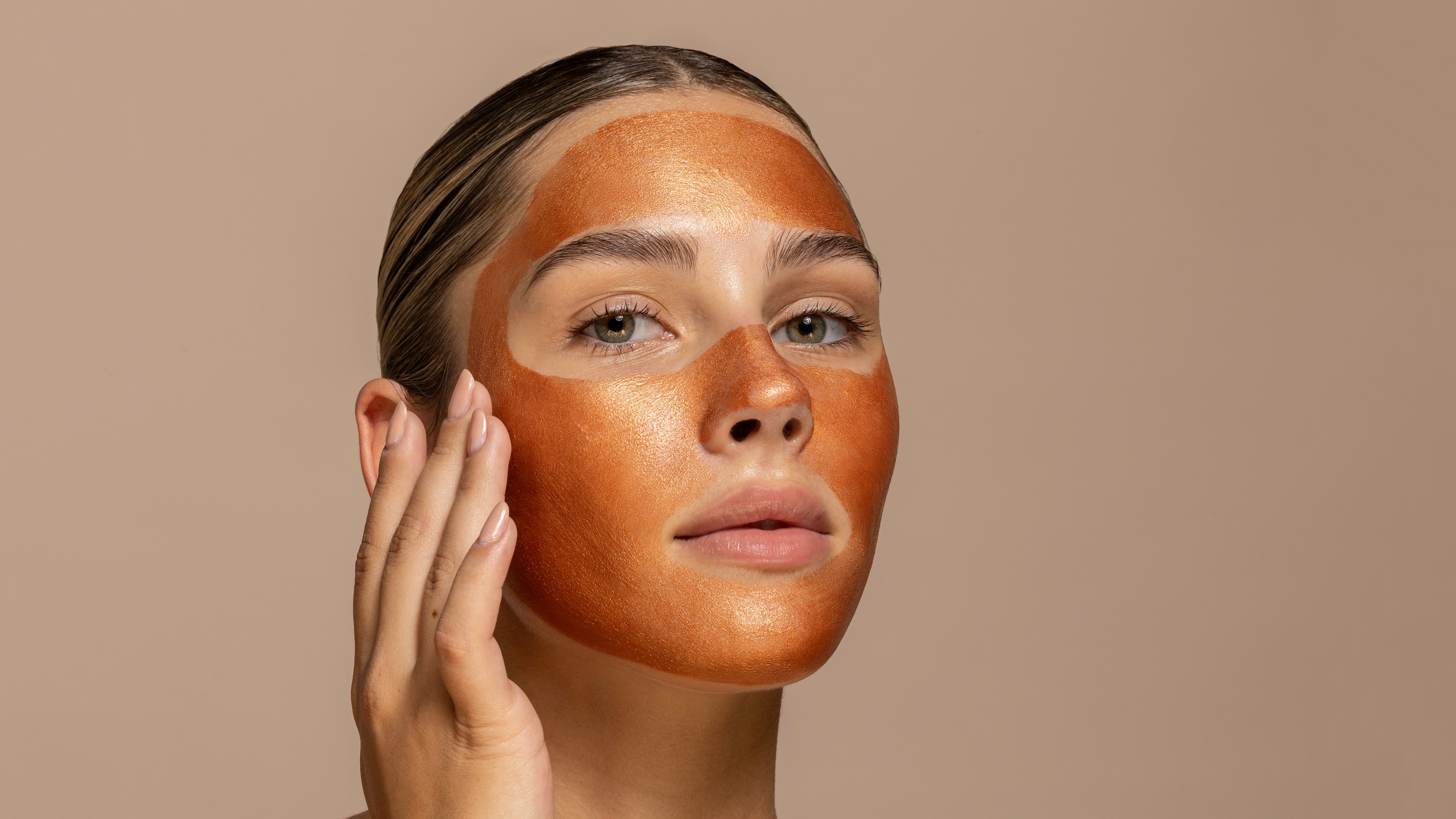 Woman with bronzed makeup on a beige background